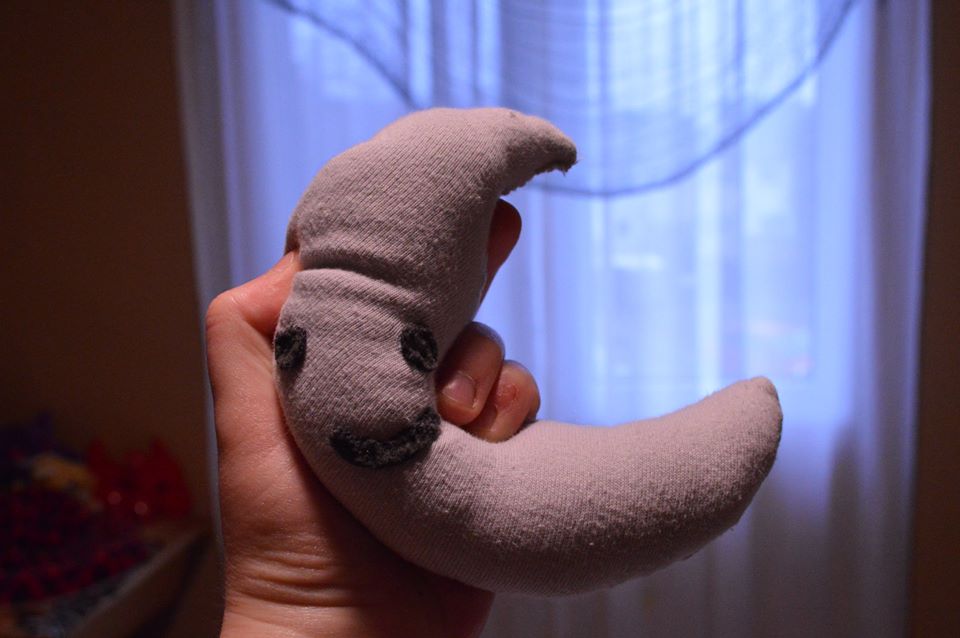 a plush toy shaped like a partial moon