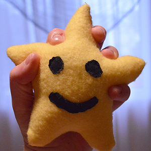 a small star shaped plush toy with a face