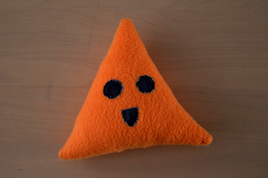 triangle shaped plush toy with face