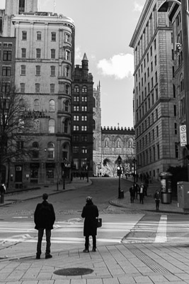 Two people about to cross the street