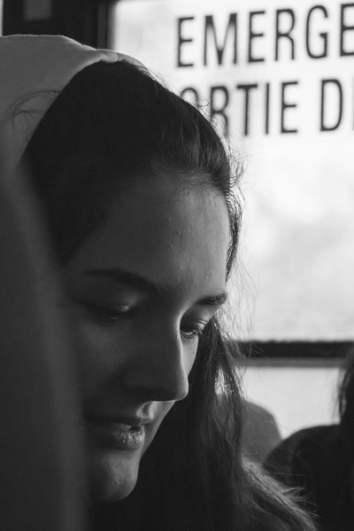 This is a close-up photo of a girl sitting in a schoolbus, it uses very low exposure