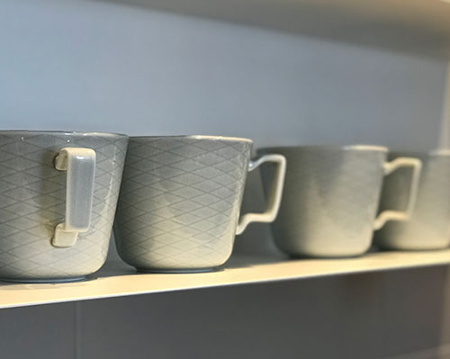 Grey mugs on a shelf