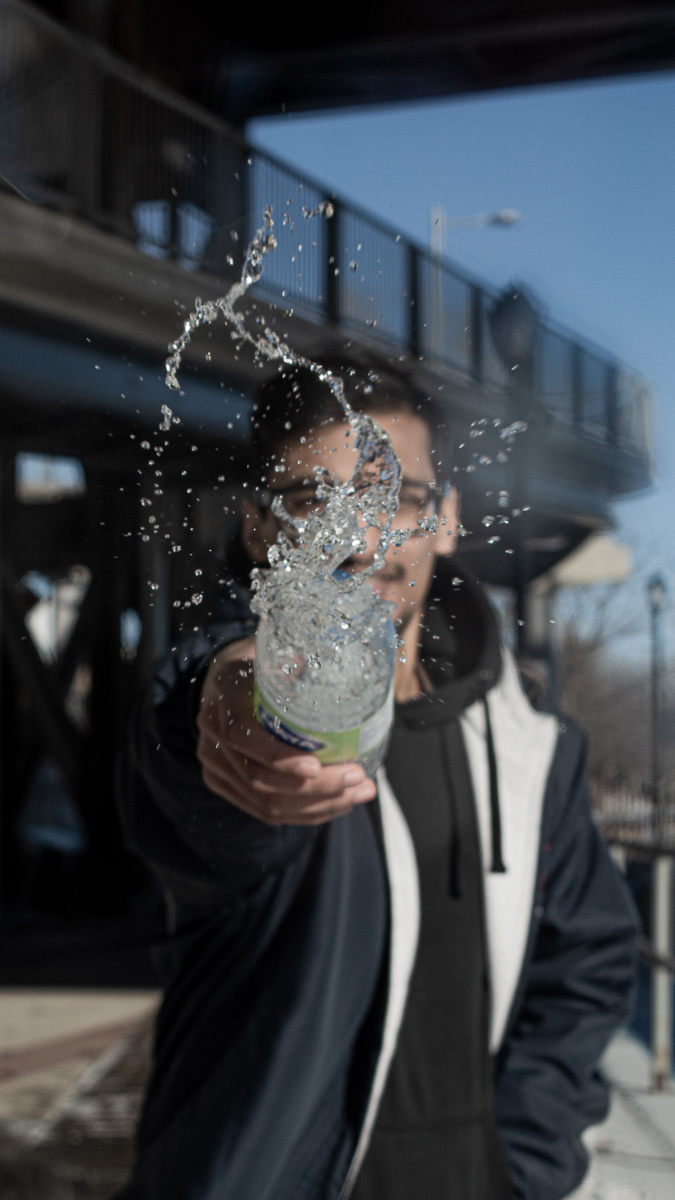 Creative photo spraying water at camera