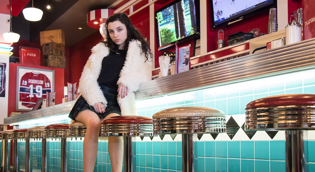 vibrant colour 1950s style photography of a girl in a diner